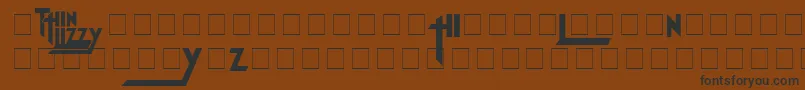 フォントThinLizzyJailbreak – 黒い文字が茶色の背景にあります