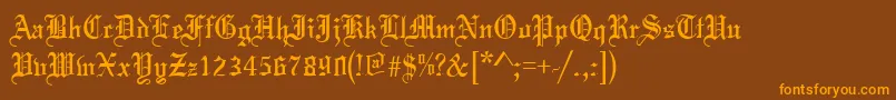 フォントToccataRegular – オレンジ色の文字が茶色の背景にあります。