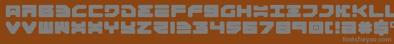 Omega3Expanded-fontti – harmaat kirjasimet ruskealla taustalla