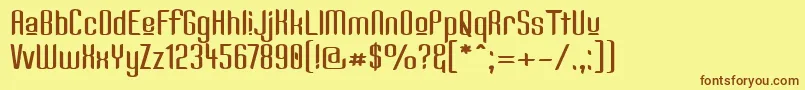 フォントKandideUpperWide – 茶色の文字が黄色の背景にあります。