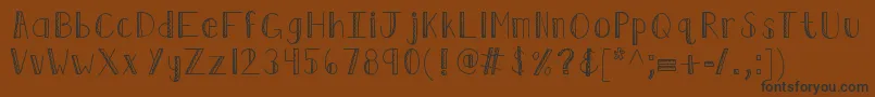 Kbruffledfeathers-fontti – mustat fontit ruskealla taustalla