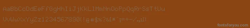 JdLcdRounded-fontti – harmaat kirjasimet ruskealla taustalla