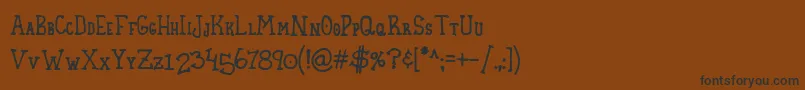 HomespunSmallCaps-Schriftart – Schwarze Schriften auf braunem Hintergrund