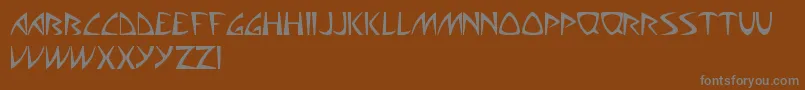 AliensCanSuckIt-Schriftart – Graue Schriften auf braunem Hintergrund