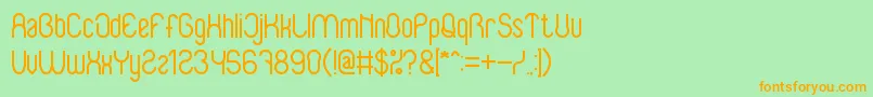 フォントBabySuperhero – オレンジの文字が緑の背景にあります。