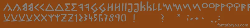 フォントCapitalisGoreanis – 茶色の背景に灰色の文字