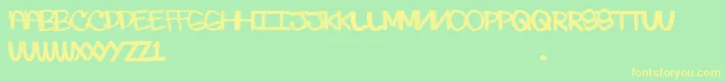 フォントSkratchie – 黄色の文字が緑の背景にあります