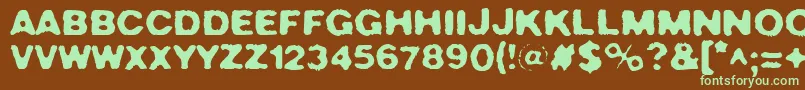 フォントCrush49 – 緑色の文字が茶色の背景にあります。