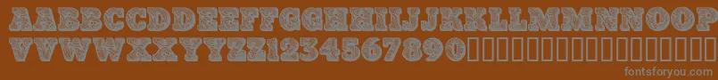 Paisleycaps-Schriftart – Graue Schriften auf braunem Hintergrund