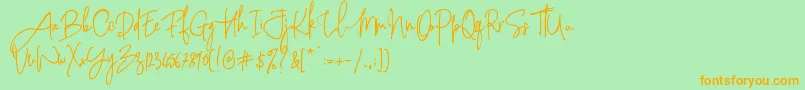 フォントPinkScriptR1 – オレンジの文字が緑の背景にあります。