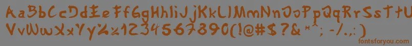 フォントGyosho – 茶色の文字が灰色の背景にあります。