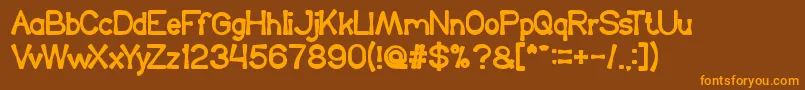 フォントKingOfTheWorld – オレンジ色の文字が茶色の背景にあります。