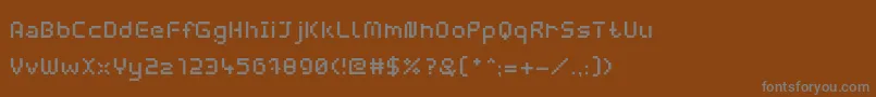 Fonte WebpixelBitmapMedium – fontes cinzas em um fundo marrom