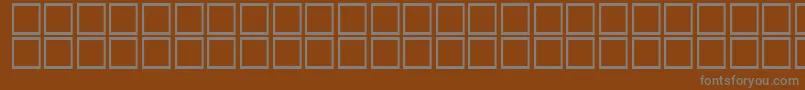 AlBattar-fontti – harmaat kirjasimet ruskealla taustalla