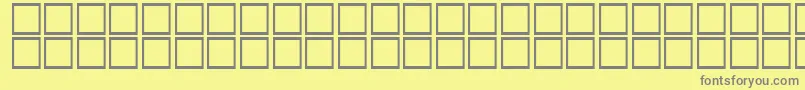 AlBattar-fontti – harmaat kirjasimet keltaisella taustalla