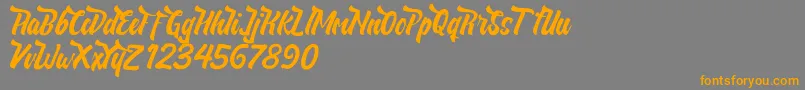 フォントNeldaFree – オレンジの文字は灰色の背景にあります。