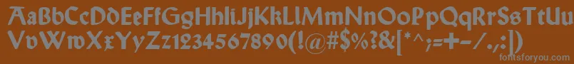 WallauUnzialBold-fontti – harmaat kirjasimet ruskealla taustalla
