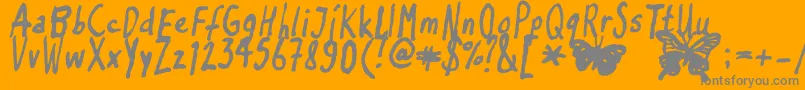 Inkyflutterby-fontti – harmaat kirjasimet oranssilla taustalla