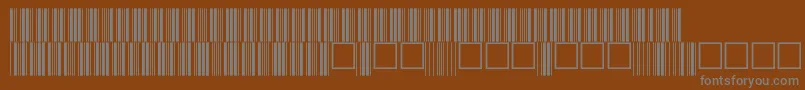 V100015-fontti – harmaat kirjasimet ruskealla taustalla