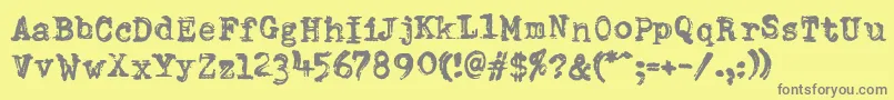 DumboldtypewriterDoublepunch-fontti – harmaat kirjasimet keltaisella taustalla