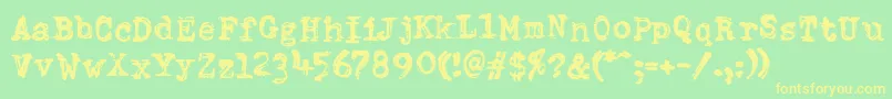 フォントDumboldtypewriterDoublepunch – 黄色の文字が緑の背景にあります