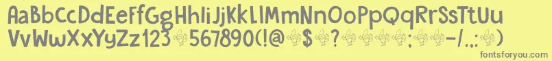DkGardenGnome-fontti – harmaat kirjasimet keltaisella taustalla