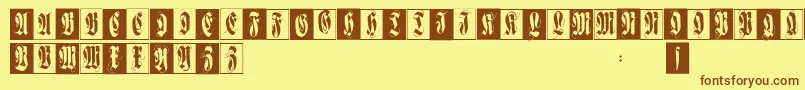 フォントFlourishfraxcaps – 茶色の文字が黄色の背景にあります。