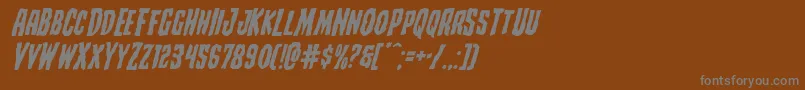 Creepycrawlersexpandital-fontti – harmaat kirjasimet ruskealla taustalla