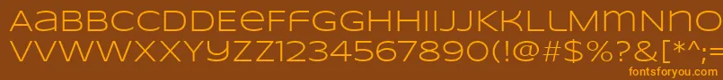 SyncopateRegular-Schriftart – Orangefarbene Schriften auf braunem Hintergrund