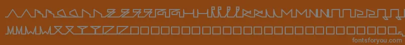 LifeSLines-fontti – harmaat kirjasimet ruskealla taustalla