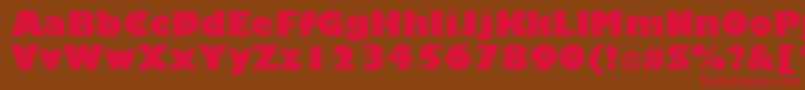 フォントTrumaniaEenPlain – 赤い文字が茶色の背景にあります。