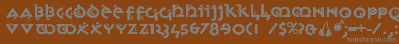 フォントMonkeyuncialica – 茶色の背景に灰色の文字