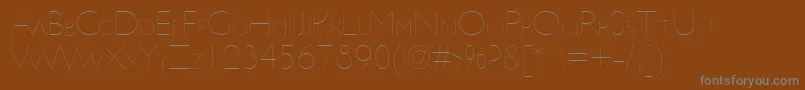 Fonte UltimapdbaHairlinesmallcap – fontes cinzas em um fundo marrom