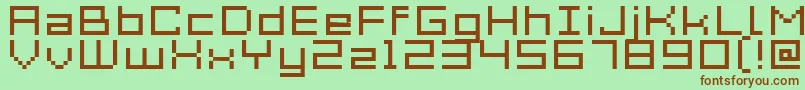 Acme7WideXtnd-fontti – ruskeat fontit vihreällä taustalla