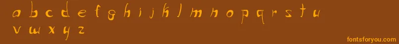 フォントWriteThatDown – オレンジ色の文字が茶色の背景にあります。