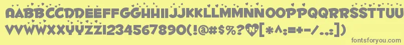 Weitere Informationen zur Fontdinerdotcom Luvable-Schriftart Fontdinerdotcom Luvable-Schriftart – Graue Schriften auf gelbem Hintergrund
