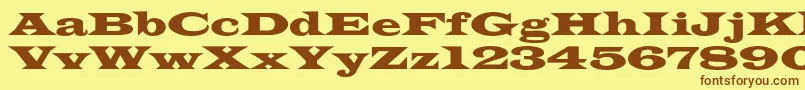 フォントAzlatinwidec – 茶色の文字が黄色の背景にあります。