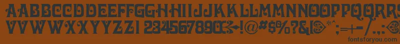 VictorianadisplaycapssskRegular Font – Black Fonts on Brown Background