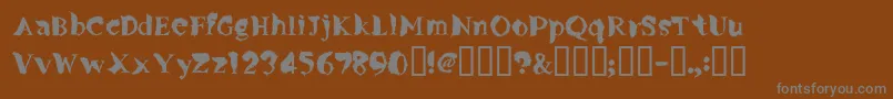 Flylegs-fontti – harmaat kirjasimet ruskealla taustalla