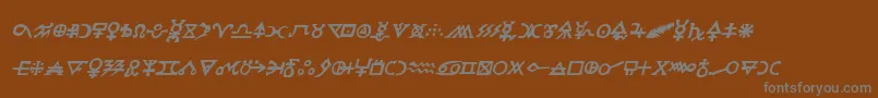 Hermeticspellbookital-fontti – harmaat kirjasimet ruskealla taustalla