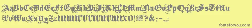 Kalmari-fontti – harmaat kirjasimet keltaisella taustalla