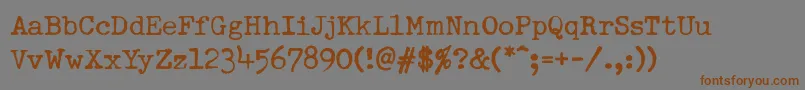 フォントDumboldtypewriterNormal – 茶色の文字が灰色の背景にあります。