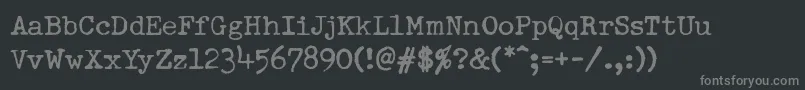 Fonte DumboldtypewriterNormal – fontes cinzas em um fundo preto