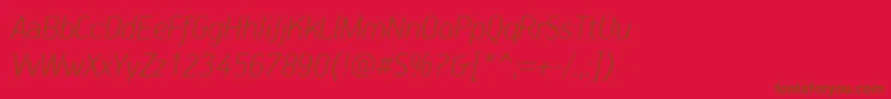 PfhandbookproThinitalic-fontti – ruskeat fontit punaisella taustalla