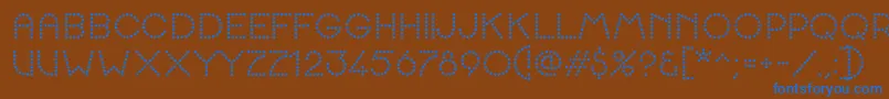 K22SpottyFace Font – Blue Fonts on Brown Background