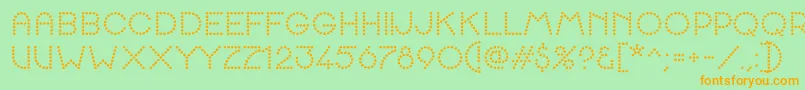 Czcionka K22SpottyFace – pomarańczowe czcionki na zielonym tle