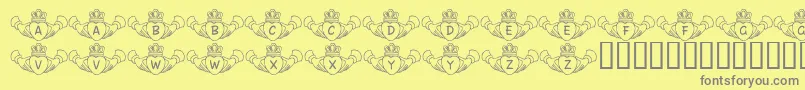 FlCladdagh-fontti – harmaat kirjasimet keltaisella taustalla