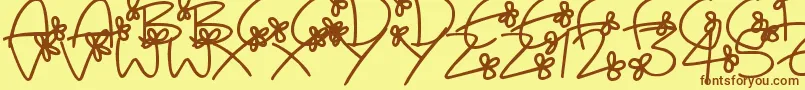 フォントFlowingFlowers – 茶色の文字が黄色の背景にあります。