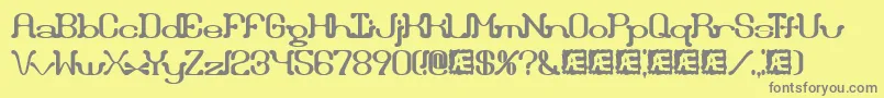 フォントDraggleOverKernedBrk – 黄色の背景に灰色の文字