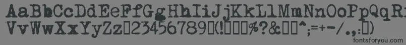 MomsTypewriter-fontti – mustat fontit harmaalla taustalla